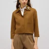 Giacca boxy con spilla gioiello