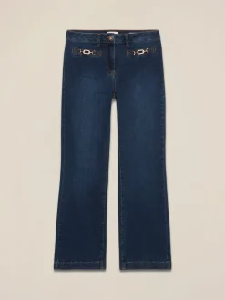 Jeans kick flare con fibbie metalliche