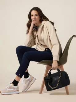 Jeans skinny blu rinse con bottoni sul fondo gamba