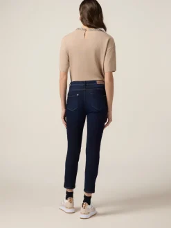 Jeans skinny blu rinse con bottoni sul fondo gamba