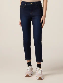 Jeans skinny blu rinse con bottoni sul fondo gamba