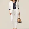 Pantaloni skinny in cotone e tencel con bottone gioiello